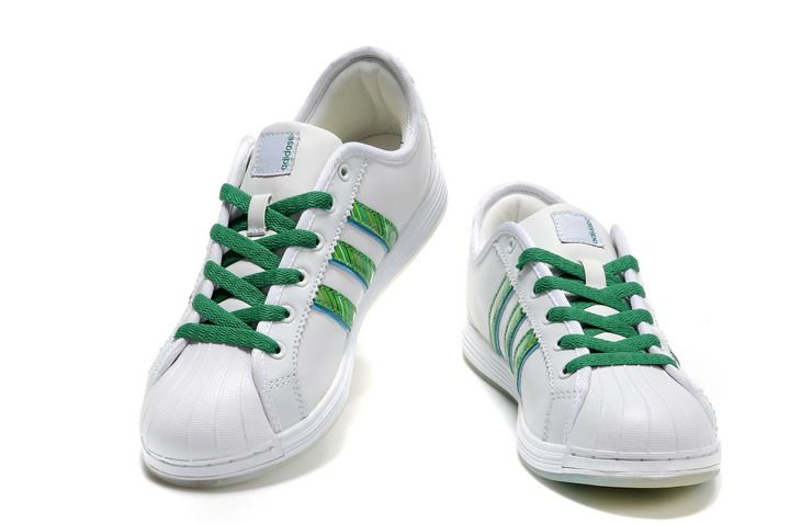 white adidas with green stripes